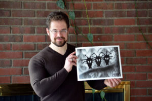 Christopher Paolini holding his print of the Shadow Birds, Halloween