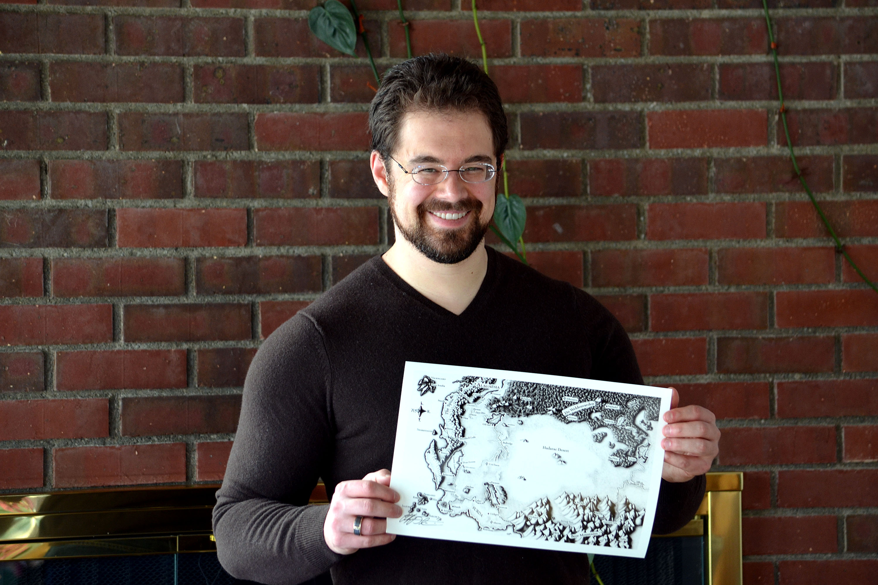Christopher Paolini holding his print of the Map of Alagaësia.