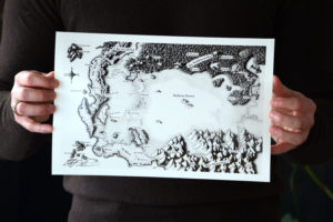 Detail of Christopher Paolini holding his print of the Map of Alagaësia.