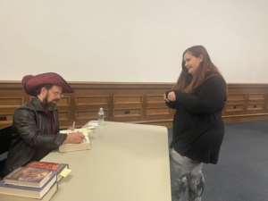 Christopher Paolini signing book for fan, photo courtesy @KaraRasmussen on Facebook